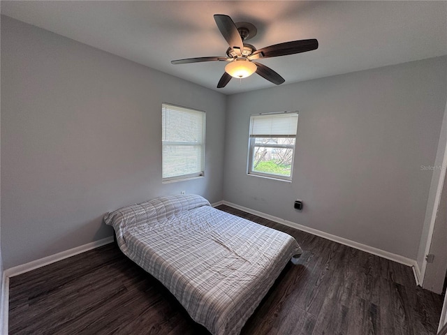 bedroom with dark hardwood / wood-style floors and ceiling fan