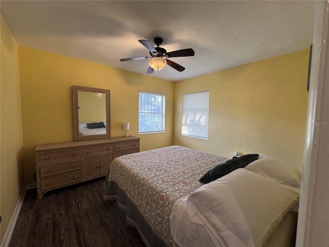 bedroom with dark wood-type flooring and ceiling fan