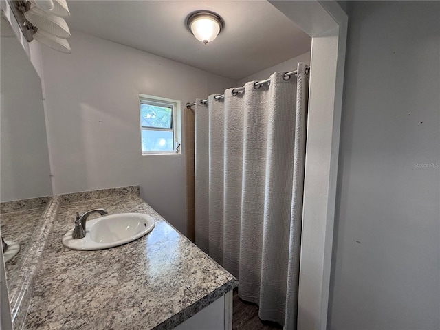 bathroom featuring vanity and a shower with shower curtain