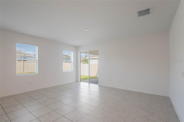 unfurnished room featuring light tile patterned floors