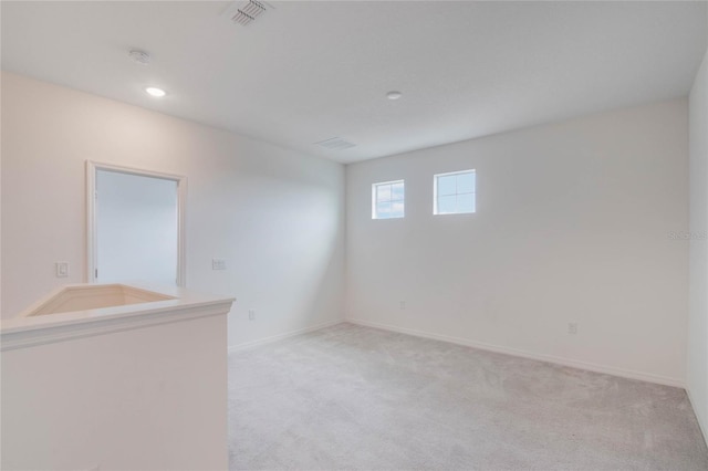 unfurnished room featuring light colored carpet