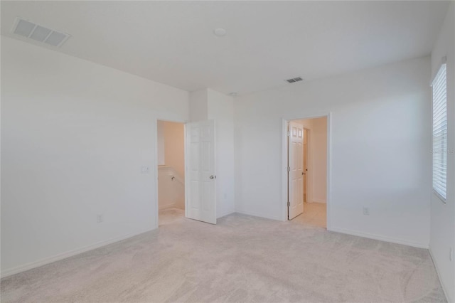 empty room featuring light carpet