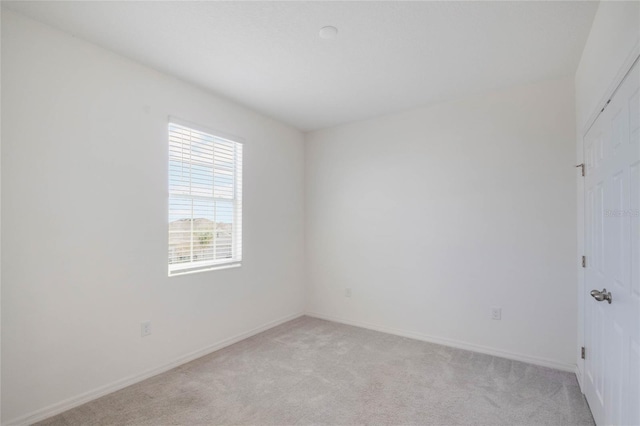 empty room featuring light colored carpet