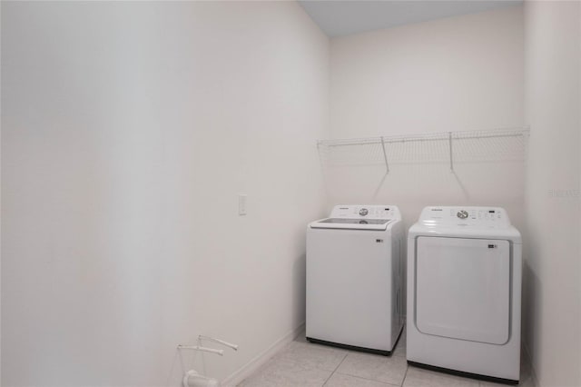 laundry room featuring light tile patterned flooring and washer and dryer