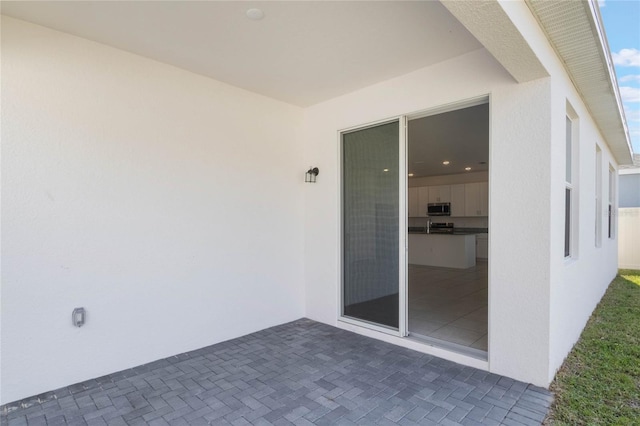 doorway to property with a patio