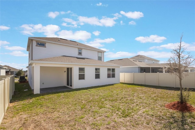 rear view of house featuring a lawn