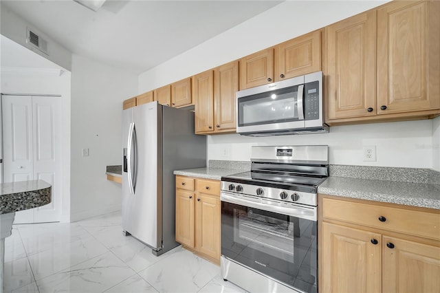 kitchen with appliances with stainless steel finishes and light brown cabinets