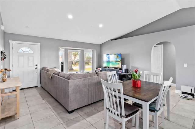 tiled living room featuring lofted ceiling