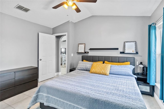 tiled bedroom with lofted ceiling and ceiling fan