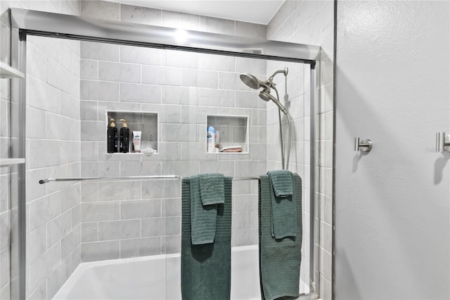 bathroom featuring shower / bath combination with glass door