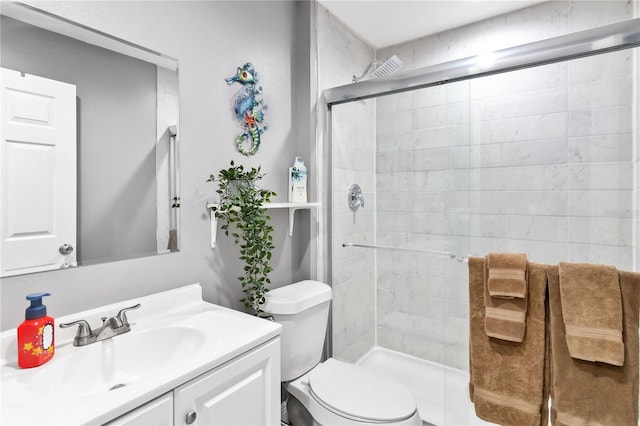 bathroom featuring vanity, an enclosed shower, and toilet