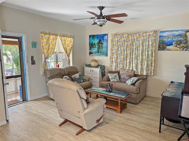 living room featuring light hardwood / wood-style floors and ceiling fan