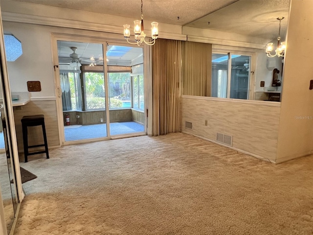 interior space with ceiling fan with notable chandelier and carpet floors