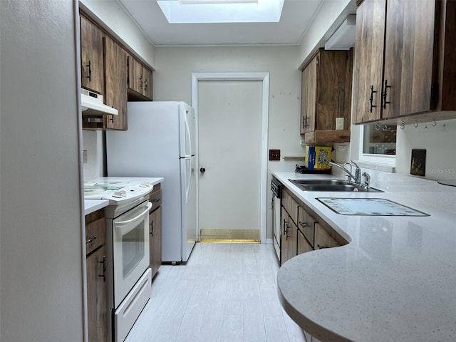 kitchen featuring sink, white range with electric cooktop, a skylight, black dishwasher, and light hardwood / wood-style floors