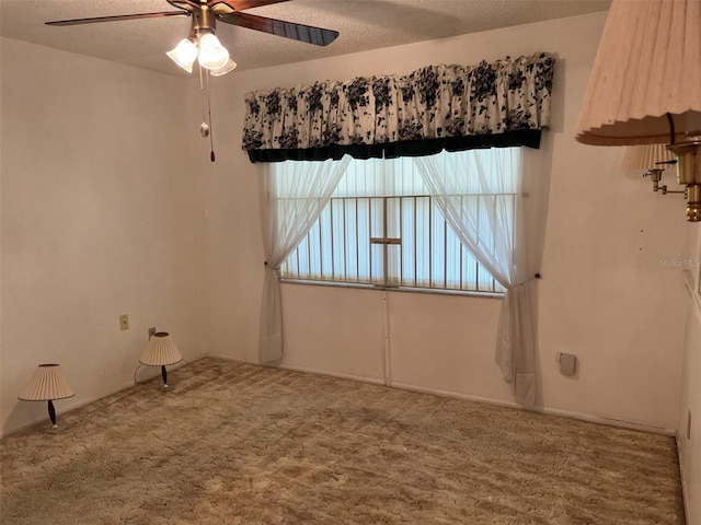 spare room with ceiling fan, carpet floors, and a textured ceiling