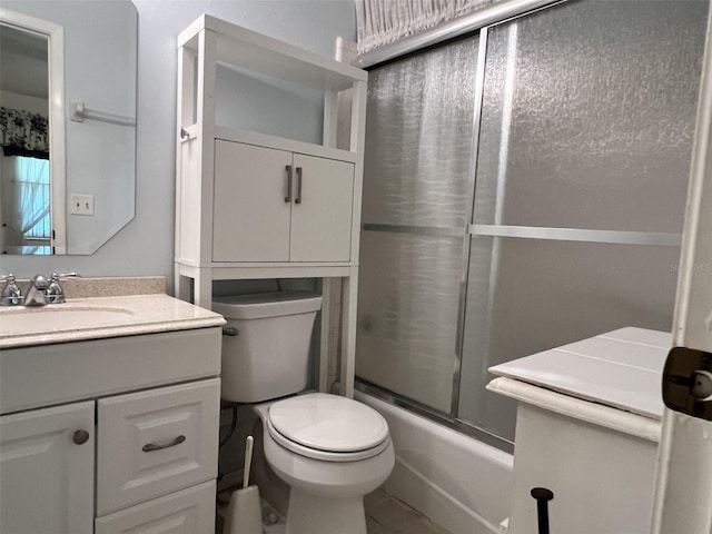 full bathroom featuring vanity, toilet, and combined bath / shower with glass door