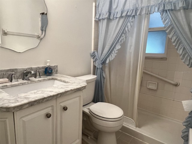 bathroom featuring vanity, tile patterned floors, toilet, and walk in shower