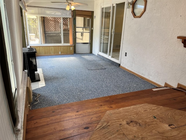 unfurnished sunroom featuring ceiling fan