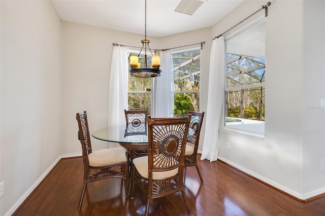 dining room featuring a chandelier and dark hardwood / wood-style flooring