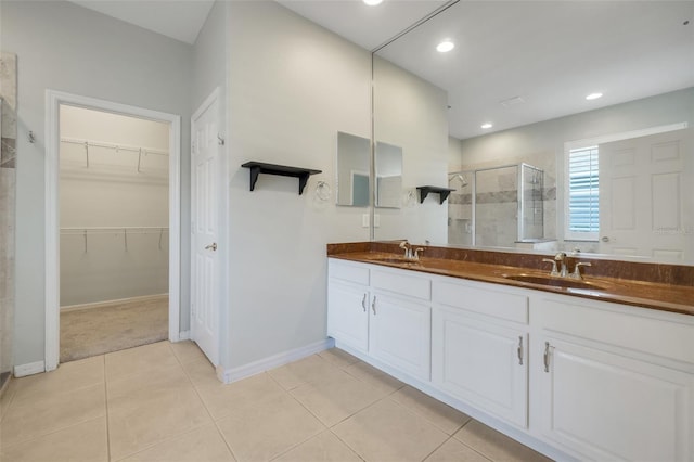 bathroom with vanity, tile patterned floors, and a shower with shower door