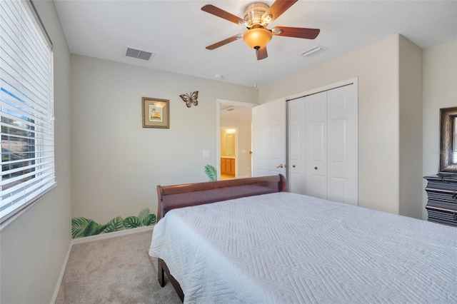 carpeted bedroom with a closet and ceiling fan