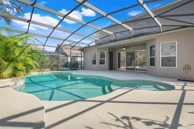 view of pool featuring ceiling fan, a lanai, and a patio area