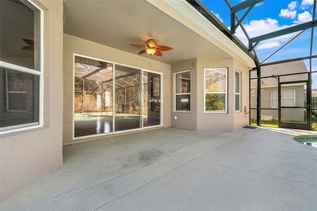 view of patio / terrace featuring ceiling fan and a lanai