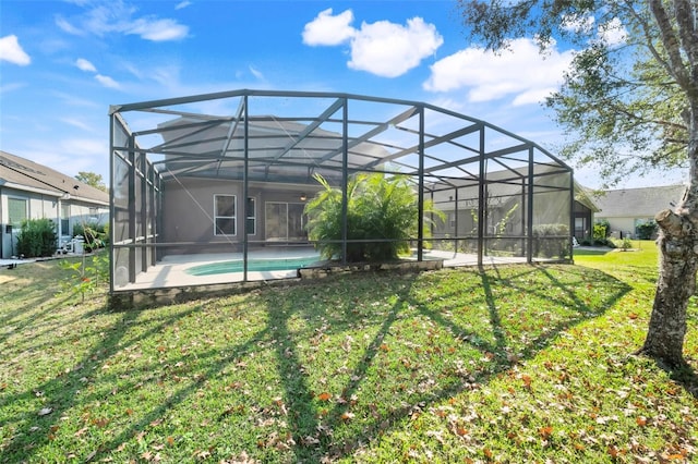 back of house featuring a patio, a lanai, and a yard