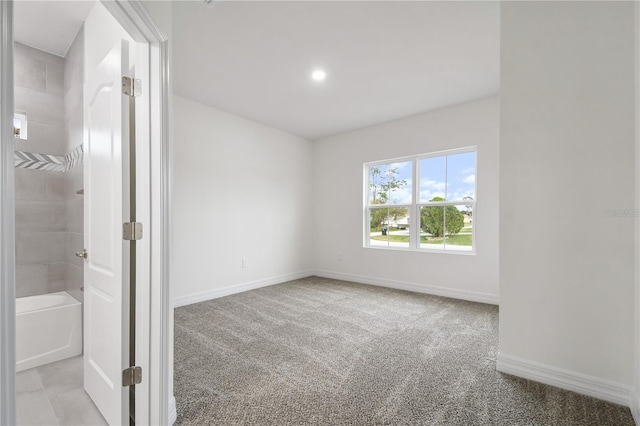 unfurnished room featuring light carpet