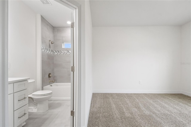 full bathroom featuring tiled shower / bath combo, vanity, and toilet