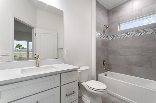 full bathroom featuring vanity, toilet, and tiled shower / bath