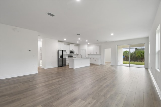 unfurnished living room featuring light wood-type flooring