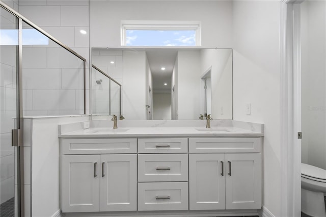 bathroom featuring walk in shower, vanity, and toilet