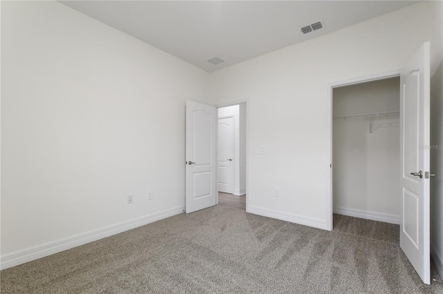 unfurnished bedroom featuring carpet floors and a closet