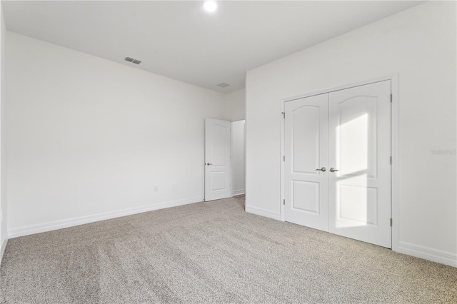 unfurnished bedroom featuring a closet and carpet flooring