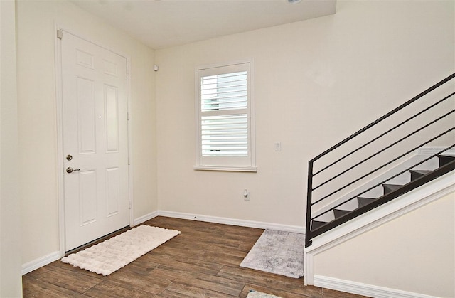 entryway with dark hardwood / wood-style flooring