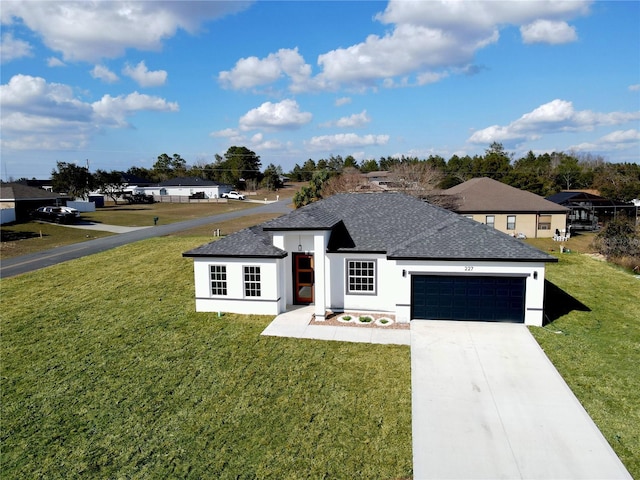 view of front of property with a garage and a front lawn