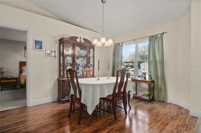 dining space featuring an inviting chandelier, dark wood-type flooring, and lofted ceiling