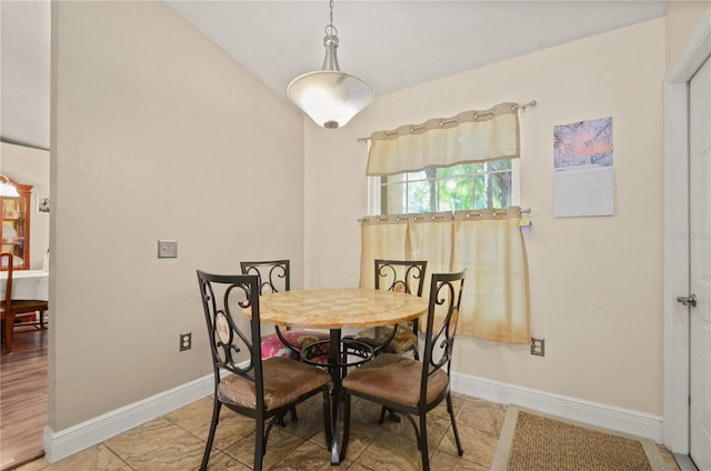 dining space with vaulted ceiling