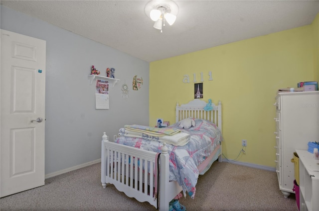 bedroom featuring light carpet and a textured ceiling