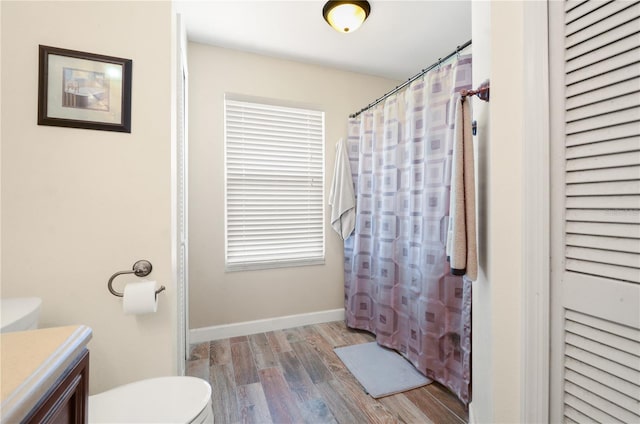 bathroom featuring vanity, hardwood / wood-style floors, and toilet