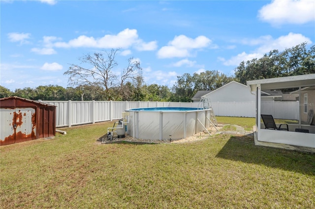 view of yard featuring a fenced in pool and a sunroom