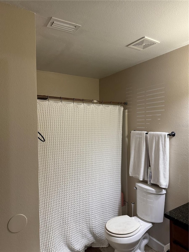 full bathroom featuring shower / bath combination with curtain, vanity, toilet, and a textured ceiling