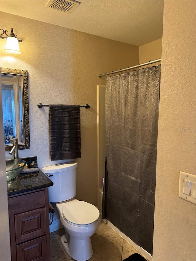 bathroom with vanity, a shower with shower curtain, tile patterned floors, and toilet