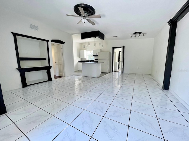 unfurnished living room with ceiling fan