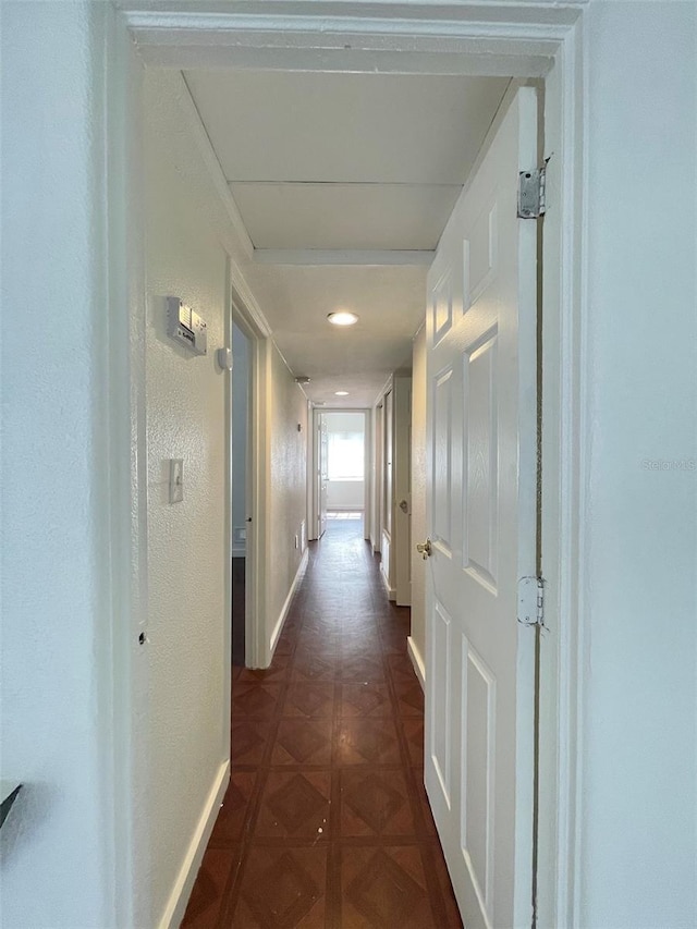 hallway with dark parquet flooring