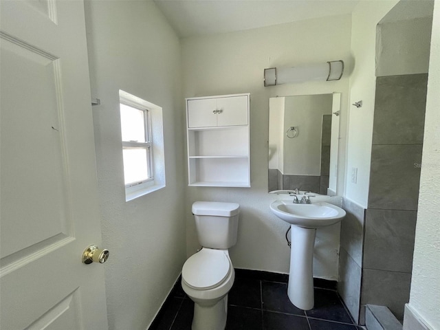 bathroom with tile patterned flooring, sink, and toilet