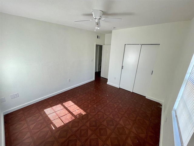 unfurnished bedroom featuring a closet and ceiling fan