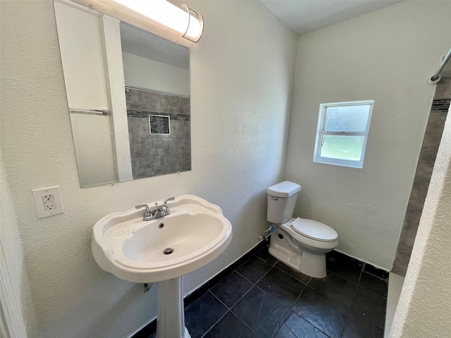 bathroom featuring tile patterned floors and toilet