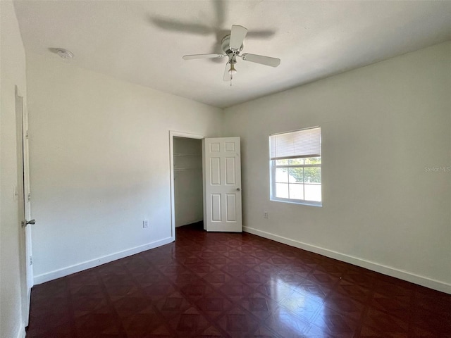 unfurnished bedroom featuring ceiling fan and a closet